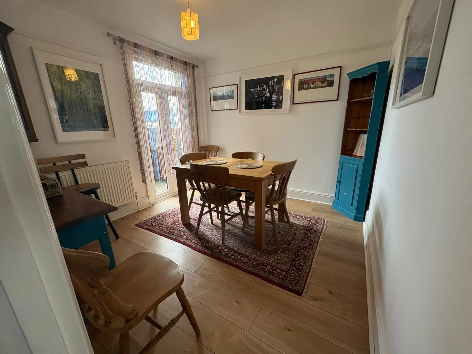 Dining room at Bude Surf Shack with a wooden table, seating for six and garden doors