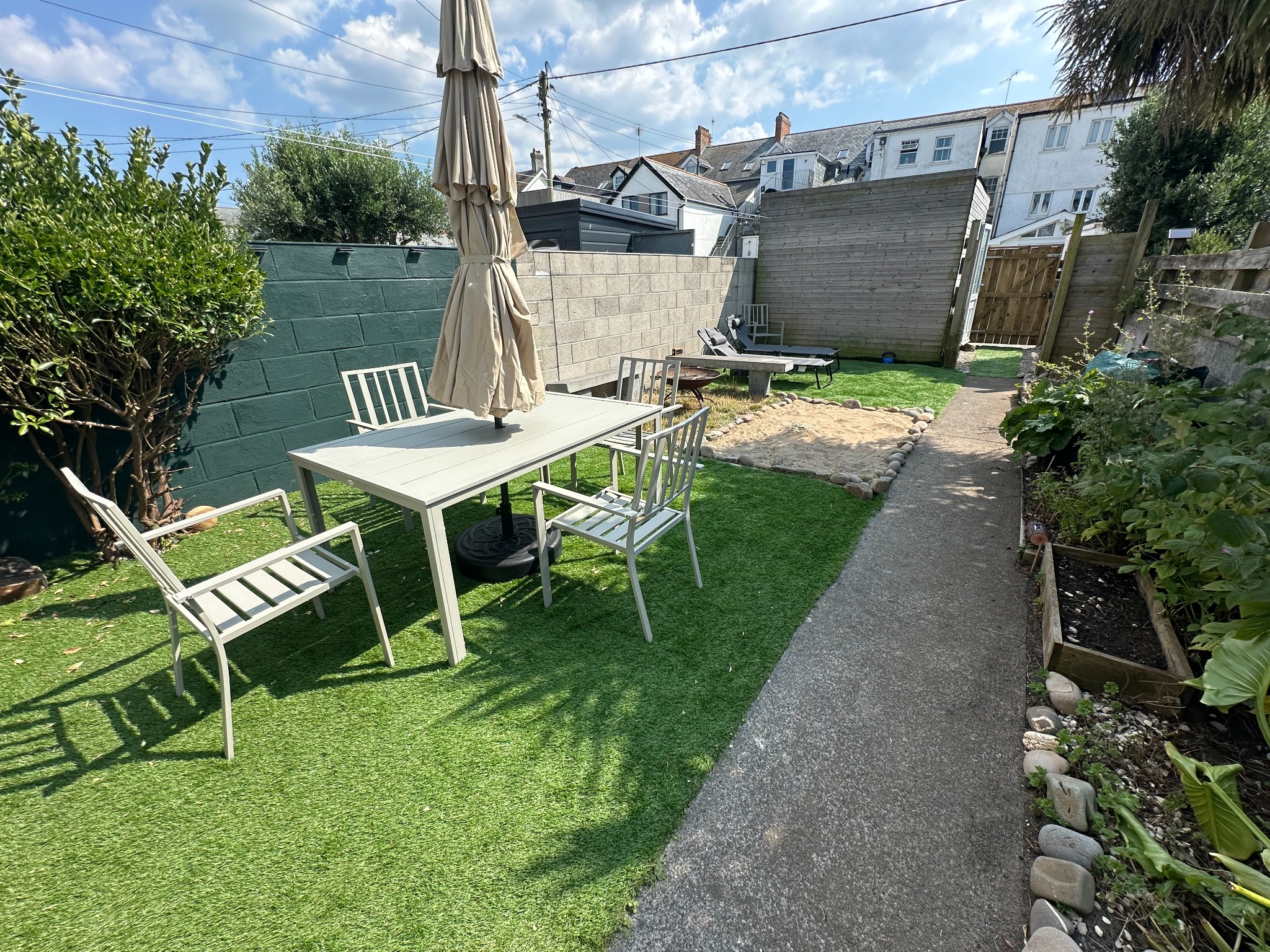 Guest-ready private south-facing garden with outdoor dining at Bude Surf Shack
